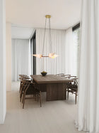 Classic Triple Pendel av Joe Armitage hengende over spisebord i mørkt tre