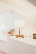 FAD bordlampe i eik på en hylle ved sengen